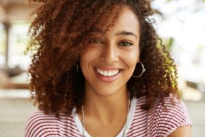 A young woman with a beautiful smile and curly hair