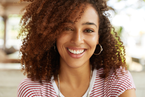 A young woman with a beautiful smile and curly hair