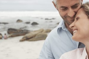 couple smiling and enjoying time at the beach together