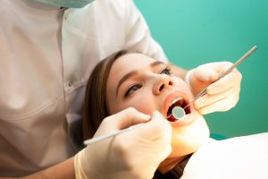 girl i dentist chair getting her teeth checked